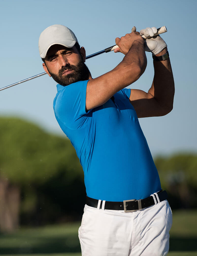 Pro golfer hitting a sand bunker shot