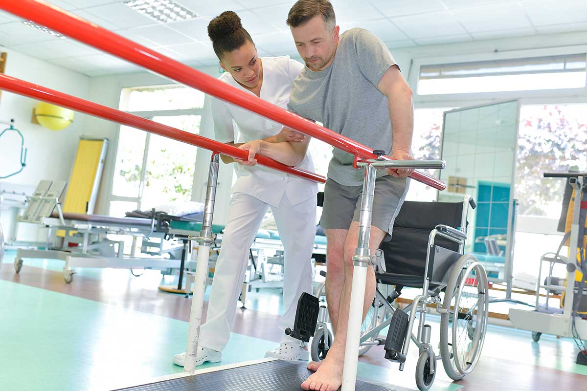 man-in-rehab-trying-to-walk-on-a-treadmill man-in-rehab-trying-to-walk-on-a-treadmill